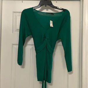 Green sweater that ties in the back.